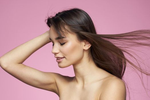 beautiful brunette naked shoulders clear skin pink background cropped view. High quality photo