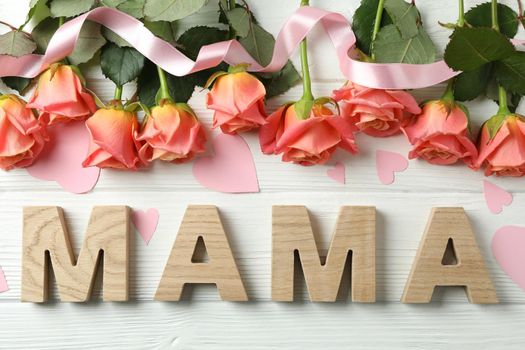 Inscription Mom with pink roses, ribbon and little hearts on wooden background, top view