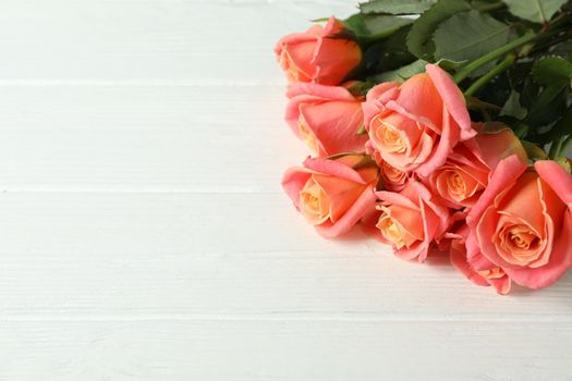 Bouquet of fresh pink roses on wooden background, closeup