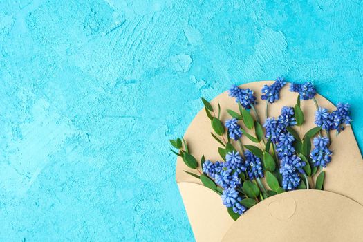 Letter with fresh hyacinths on blue background, space for text