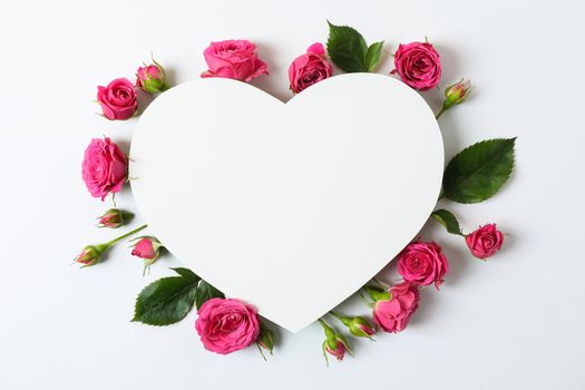 Beautiful pink roses and big heart with space for text on white background