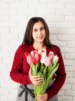 Valentine's Day and Women's Day. Small business. Woman florist holding a bouquet of fresh colorful tulips
