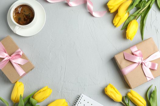 Beautiful yellow tulips and accessories on grey background, space for text. Blogger concept