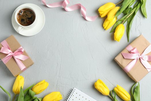 Beautiful yellow tulips and accessories on grey background, space for text. Blogging concept