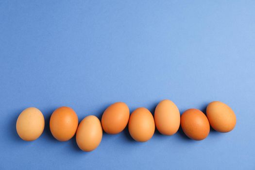 Chicken eggs on color background, space for text