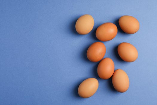 Chicken eggs on color background, space for text