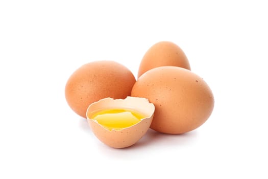 Chicken eggs and half broken egg with yolk  isolated on white background