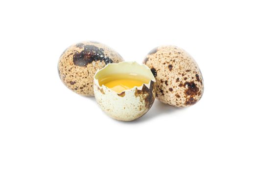 Quail eggs and half broken egg with yolk isolated on white background