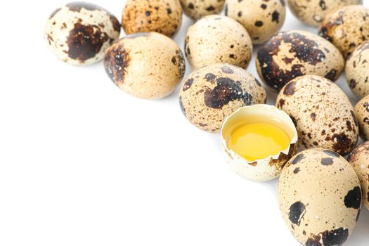 Quail eggs and half broken egg with yolk isolated on white background, closeup