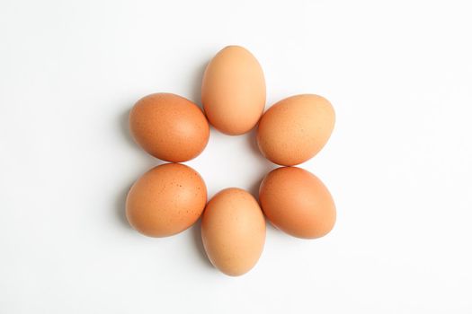 Flat lay composition with chicken eggs on white background, space for text