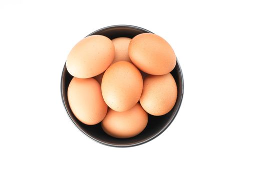 Brown chicken eggs in bowl isolated on white background, top view