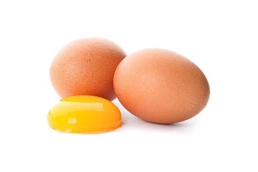 Chicken eggs and egg yolk isolated on white background