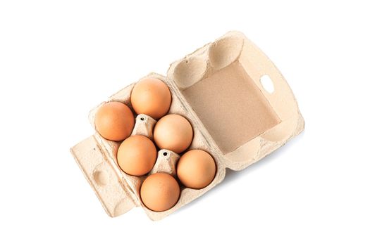 Brown chicken eggs in carton box isolated on white background. top view