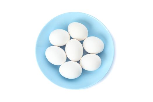 White chicken eggs in plate isolated on white background, top view