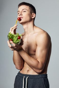 man with a plate of salad eating energy lifestyle isolated background workout. High quality photo