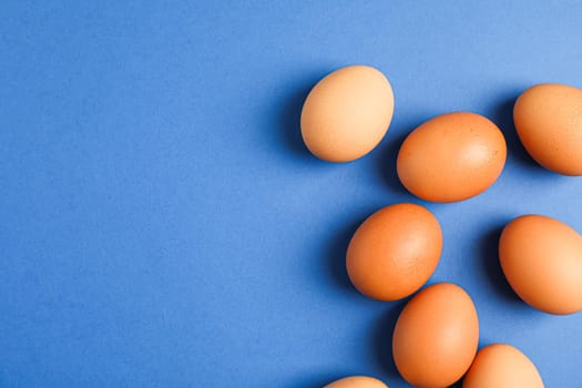 Flat lay composition with chicken eggs on color background, space for text