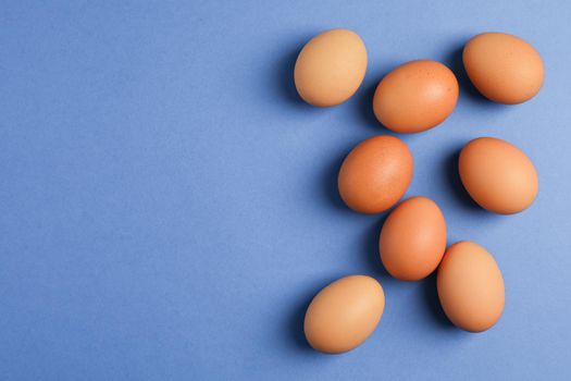 Chicken eggs on color background, space for text