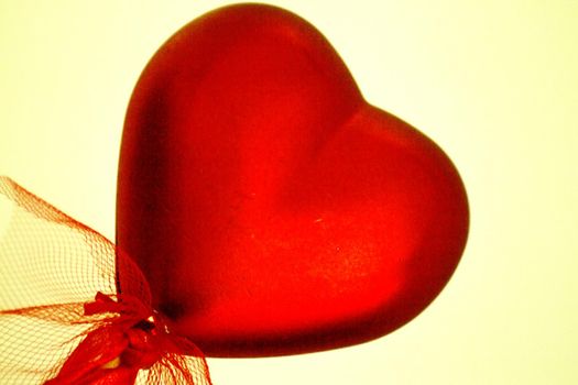 Shiny red heart on rainbow background. Copy space
