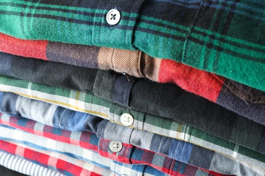 Stack of different shirts background, close up