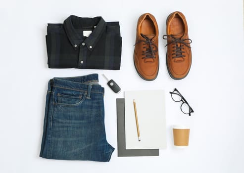 Flat lay composition with shirt, jeans, shoes and glasses on white background