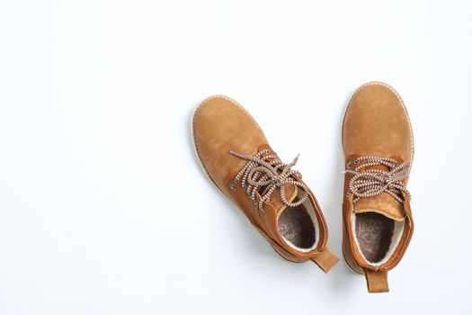 Winter boots on white background, top view