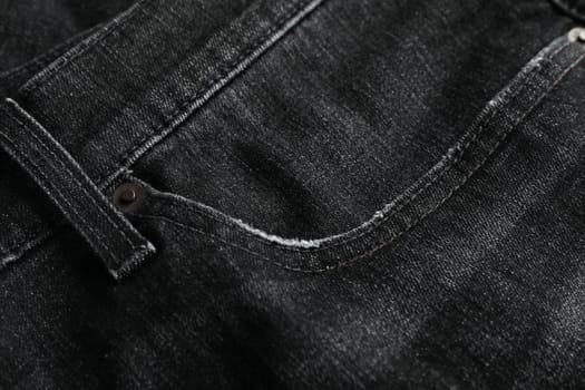 Black jeans textured background, close up