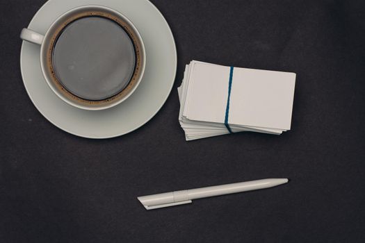 coffee cup desktop business card pen office close-up. High quality photo