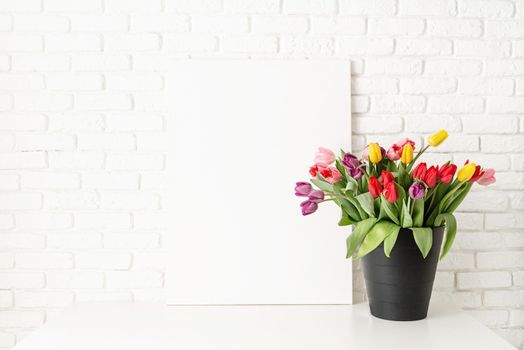 Mock up design. Mock up with Frame and bucket of tulips on white brick wall background