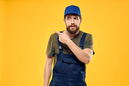 working man in uniform professional delivery service yellow background. High quality photo