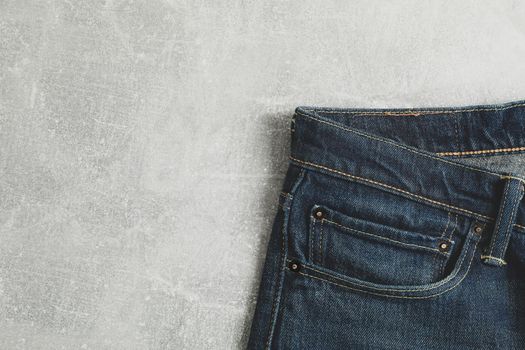 Classic jeans on grey background, space for text