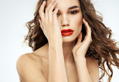 Woman model red lips eyeshadows bared shoulders portrait cropped view. High quality photo