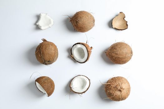 Flat lay composition with coconuts on white background