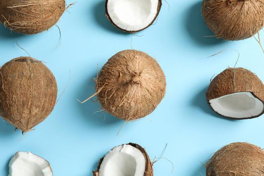 Flat lay composition with coconuts on color background