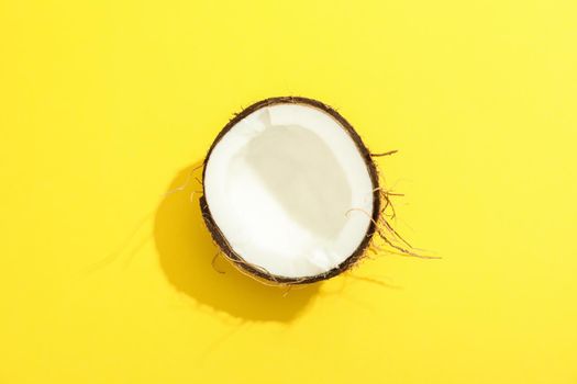 Half tropical coconut on color background, space for text