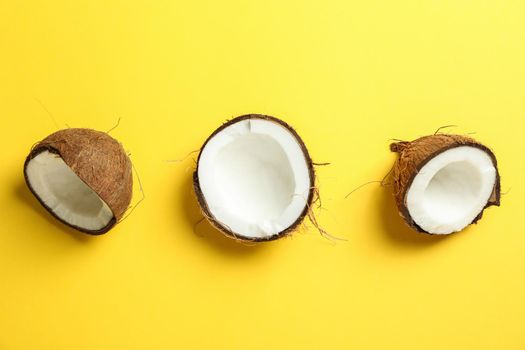 Halves coconut on color background, space for text