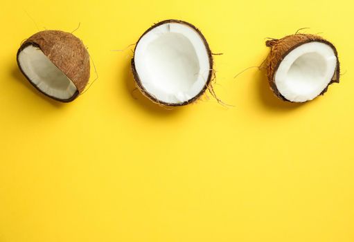 Halves coconut on color background, space for text