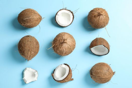 Flat lay composition with coconuts on color background
