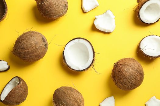 Flat lay composition with coconuts on color background