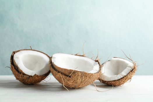 Coconuts on white wooden table against grey background