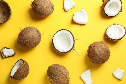 Flat lay composition with coconuts on color background