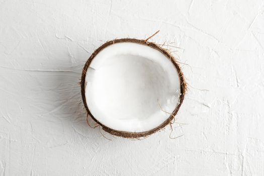 Half tropical coconut on white background, space for text