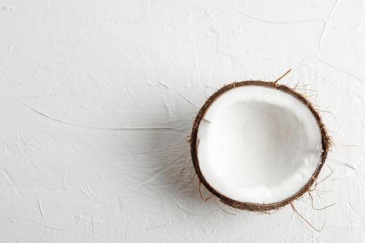 Half tropical coconut on white background, space for text