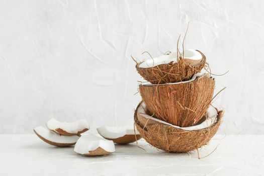 Stack tropical coconut on wooden table against white background