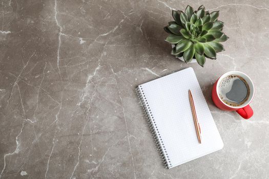 Flat lay composition with cup of coffee, copybook and succulent plant, space for text