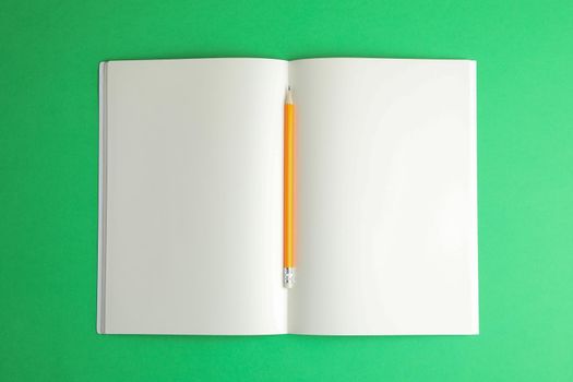 Clean copybook with pencil on color background, space for text