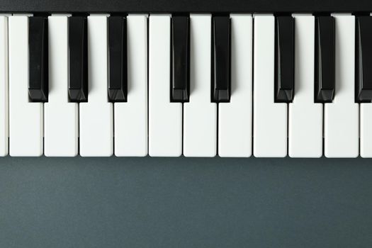 Piano keyboard on dark background, space for text