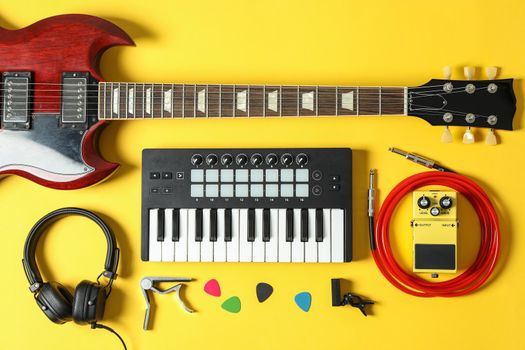 Music maker composition on color background, top view