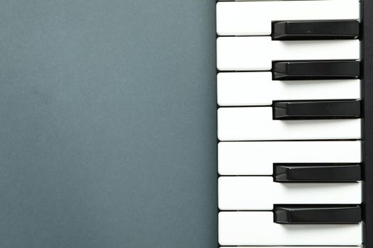Piano keyboard on dark background, space for text