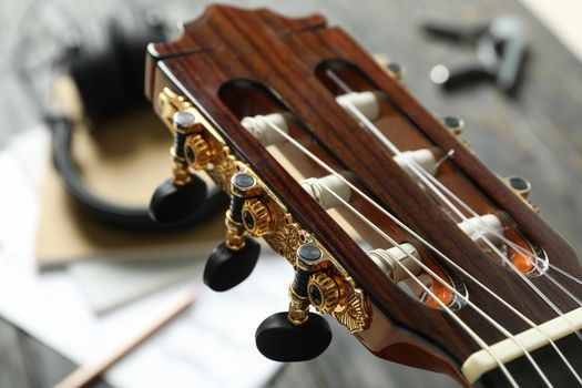 Neck head and music maker accessories against wooden background, closeup