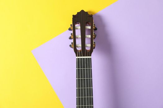 Guitar neck on two tone background, space for text